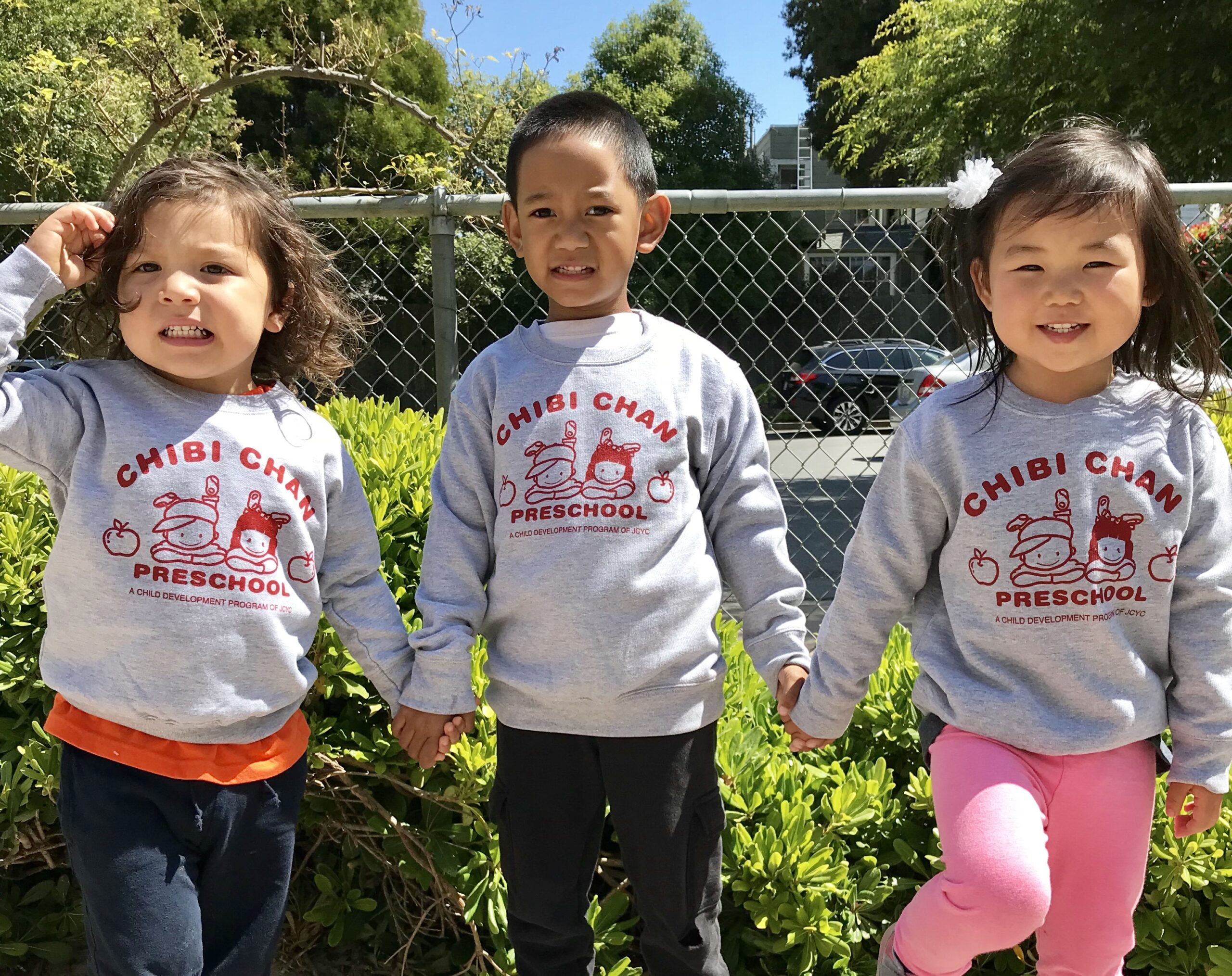 Children in Chibi Chan sweatshirts playing together in San Francisco on a sunny day