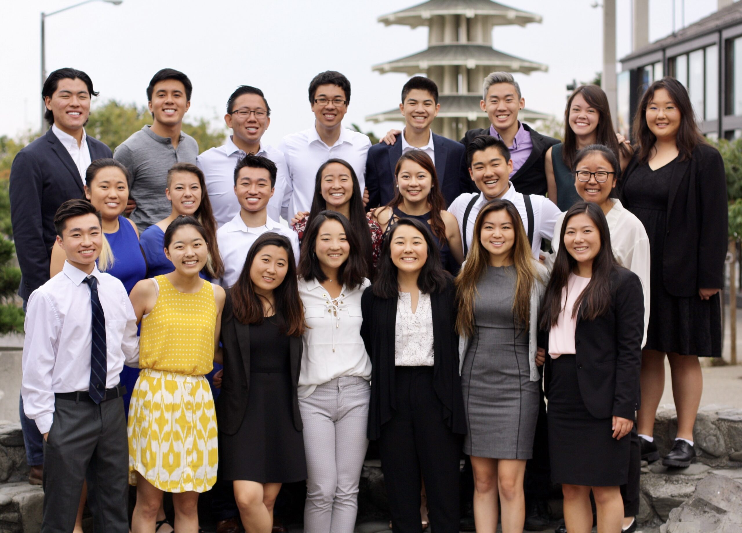 A group of Asian American teenagers dressed in business attire at a work development outing